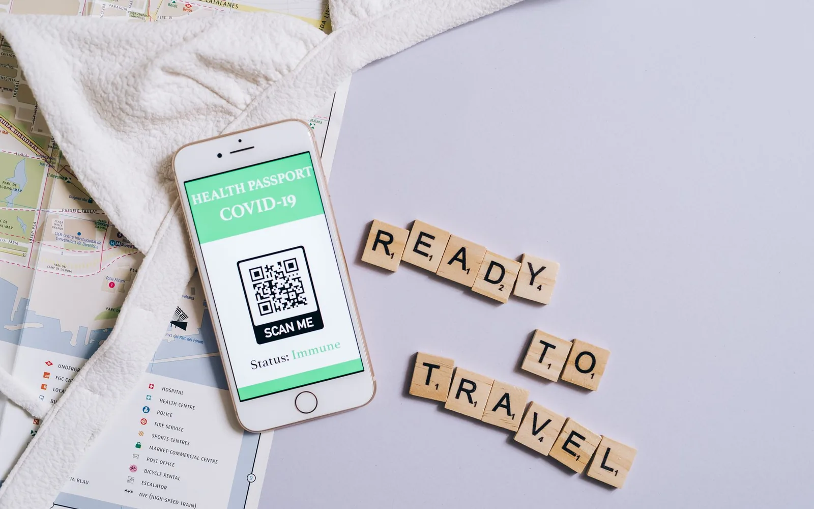 Смартфон с COVID-сертификатом рядом с буквами Scrabble, складывающимися в «Ready to Travel»